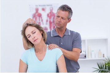 Physical Therapist stretching patients neck