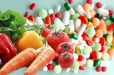 Vegetables and pills side by side